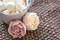 Marshmallow looks like rose close-up. cup with small marshmallows sprinkled with grated chocolate on cotton knitted napkin Royalty Free Stock Photo