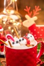 Marshmallow Snowman Melting in Hot Chocolate in Red Festive Cup