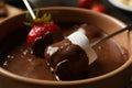 Marshmallow and strawberry in chocolate close up. Chocolate fondue Royalty Free Stock Photo