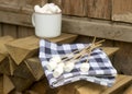 Marshmallow on wooden sticks for frying on an open fire. Rustic style, selective focus.