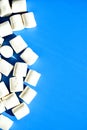 Marshmallows on blue background with Copy space. Flat lay. Top view. Background or texture of colorful mini marshmallows. Winter Royalty Free Stock Photo