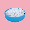 Marshmallows in blue plate on pastel pink background Royalty Free Stock Photo