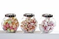 marshmallows in candy jars, isolated on white.