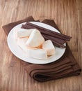 Marshmallows and chocolate sticks in plate