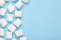 Marshmallows frame on blue background, top view with empty space for text Royalty Free Stock Photo