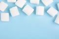 Marshmallows frame on blue background, top view with empty space for text Royalty Free Stock Photo