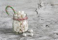 Marshmallows in a glass jar and candy - Christmas gift, on a light wooden surface Royalty Free Stock Photo