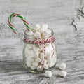 Marshmallows in a glass jar and candy - Christmas gift, on a light wooden surface Royalty Free Stock Photo