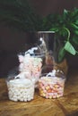 Marshmallows in glass jars on bar for sale