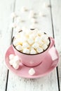 Marshmallows in pink cup on the white wooden background Royalty Free Stock Photo