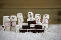 Christmas food photography picture of traditional cake and marshmallows shaped as snowman with icing used for the smiles Royalty Free Stock Photo