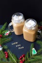 Marshmellou cocoa, Christmas tree with decorations on a black background. The inscription Happy New Year