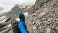 Marstein - A backpacker couple hiking through a landslide to Marstein in Austrian Alps. The slopes are mostly covered with snow Royalty Free Stock Photo