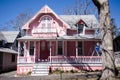 Pink Carpenter Gothic Cottages with Victorian style, gingerbread trim in the village of Oa