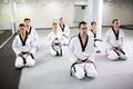 Martial artists wearing black belt, taekwondo and para-taekwondo athletes training together