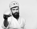 Martial arts concept. Man with beard in kimono and pink helmet on white Royalty Free Stock Photo