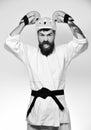 Martial arts. Man with beard in kimono and pink helmet Royalty Free Stock Photo