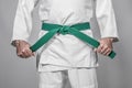 Martial arts practitioner tightening his belt