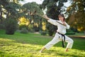 Martial arts teacher in white kimono is practicing with tonfa.