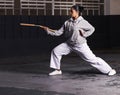 Martial arts, woman and fitness with weapon for training with nunchaku, exercise and practice for self defence at night Royalty Free Stock Photo