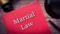 Martial law book and gavel on wooden table. Royalty Free Stock Photo