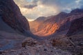 Martian landscape in mountains of Tajikistan, Pamir-Alay. Sun illuminates of rock wall on sunset in canyon of Fann mountains