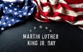 Martin Luther King Day anniversary concept. American flag against black wooden background Royalty Free Stock Photo