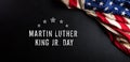 Martin Luther King Day anniversary concept. American flag against black wooden background Royalty Free Stock Photo