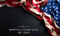 Martin Luther King Day anniversary concept. American flag against black wooden background Royalty Free Stock Photo