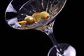 Martini on black with olives tilted
