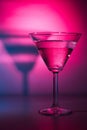 Martini cocktail drink in neon iridescent pink and blue colors. Royalty Free Stock Photo