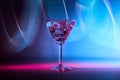 Martini cocktail drink in neon iridescent pink and blue colors. Royalty Free Stock Photo