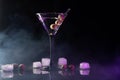 Martini cocktail drink splash with ice cubes in neon iridescent pink and blue colors. Minimal night party life concept. Royalty Free Stock Photo