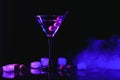 Martini cocktail drink splash with ice cubes in neon iridescent pink and blue colors. Minimal night party life concept. Royalty Free Stock Photo