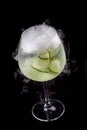 Martini cocktail, tonic and cucumber on a dark background. Isolated