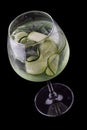 Martini cocktail, tonic and cucumber on a dark background. Isolated