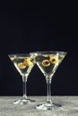 Martini cocktails with olives on grey table against dark background, space for text Royalty Free Stock Photo