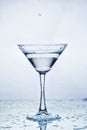 Martini glass with frozen splashing drops of drink Royalty Free Stock Photo