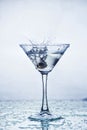 Martini glass with frozen splashing drops of drink Royalty Free Stock Photo