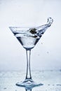 Martini glass with frozen splashing drops of drink Royalty Free Stock Photo