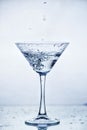 Martini glass with frozen splashing drops of drink Royalty Free Stock Photo