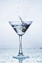 Martini glass with frozen splashing drops of drink Royalty Free Stock Photo