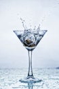Martini glass with frozen splashing drops of drink Royalty Free Stock Photo
