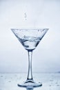 Martini glass with frozen splashing drops of drink Royalty Free Stock Photo