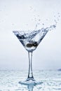 Martini glass with frozen splashing drops of drink Royalty Free Stock Photo