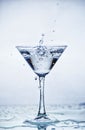 Martini glass with frozen splashing drops of drink Royalty Free Stock Photo