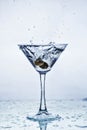 Martini glass with frozen splashing drops of drink Royalty Free Stock Photo