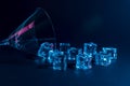 Martini glass with ice cubes in neon holographic vibrant pink and blue colors. Minimal celebration concept Royalty Free Stock Photo