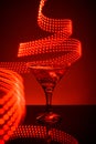 Martini glass on a red background with lights Royalty Free Stock Photo