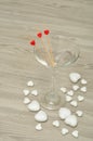 A martini glass with three sticks decorated with hearts Royalty Free Stock Photo